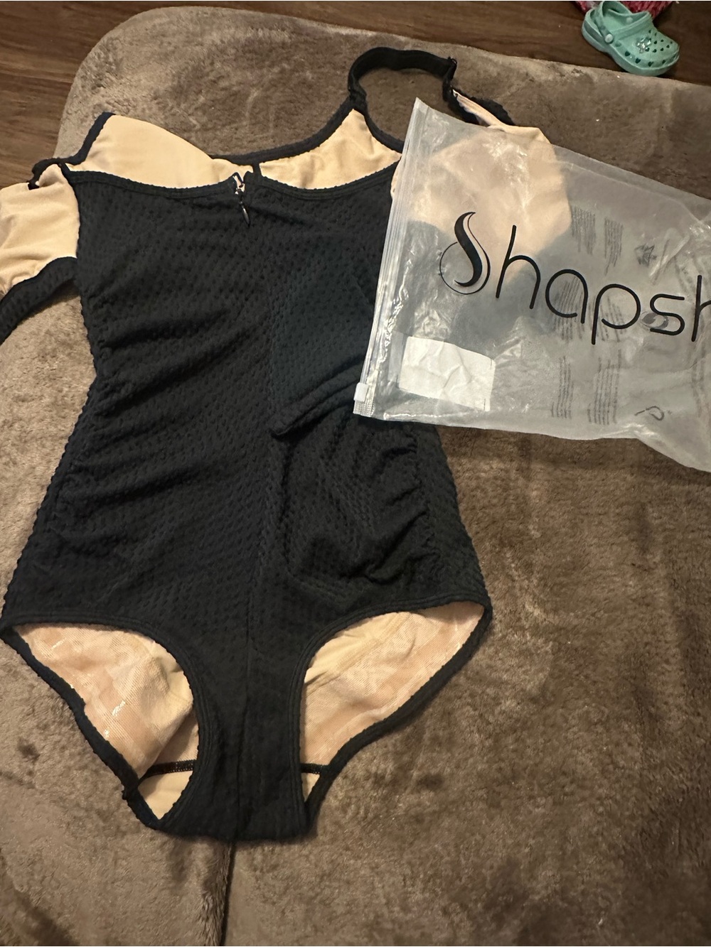Shape-enhancing Black One-Piece Swimsuit with Nude Lining